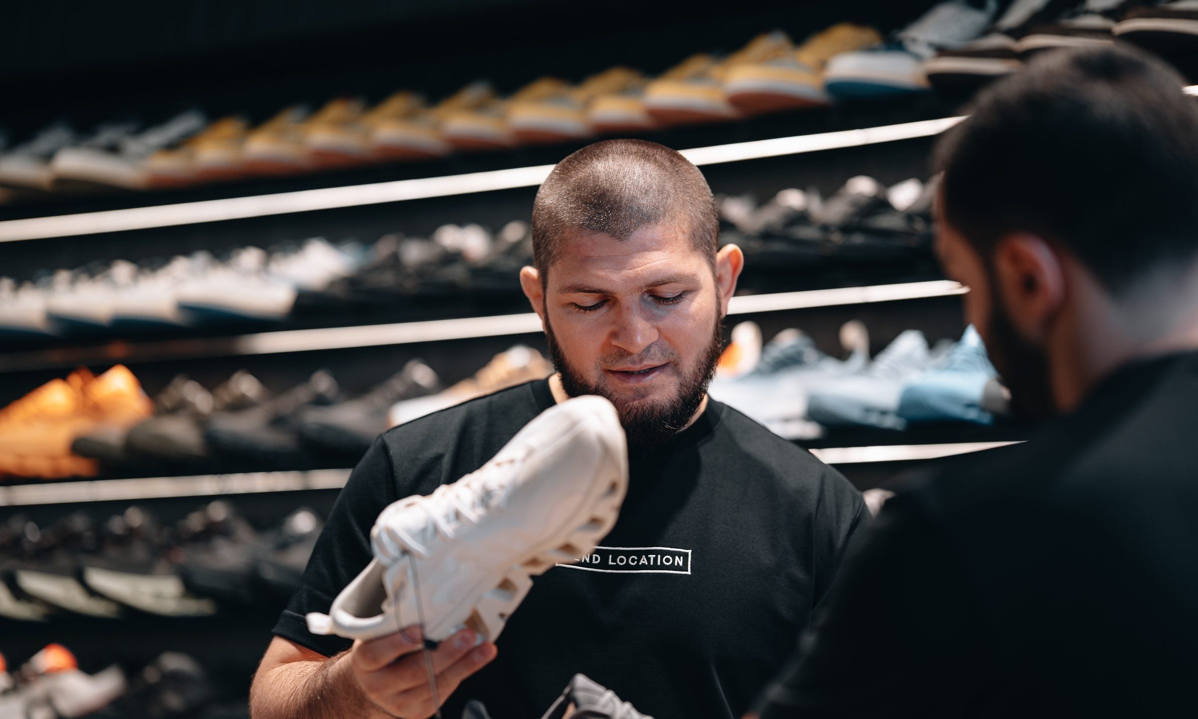 Khabib Nurmagomedov inspecting a sneaker at Send Location, Dubai